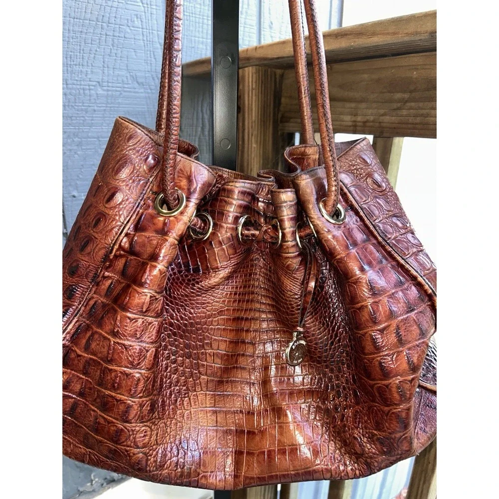 brown Brahmin bucket bag features croc-embossed leather